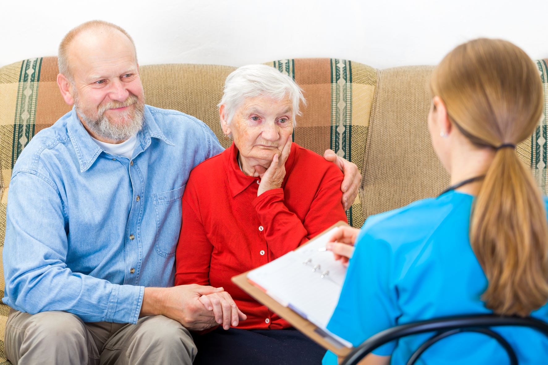 middle-aged man with senior woman and red-headed clinician