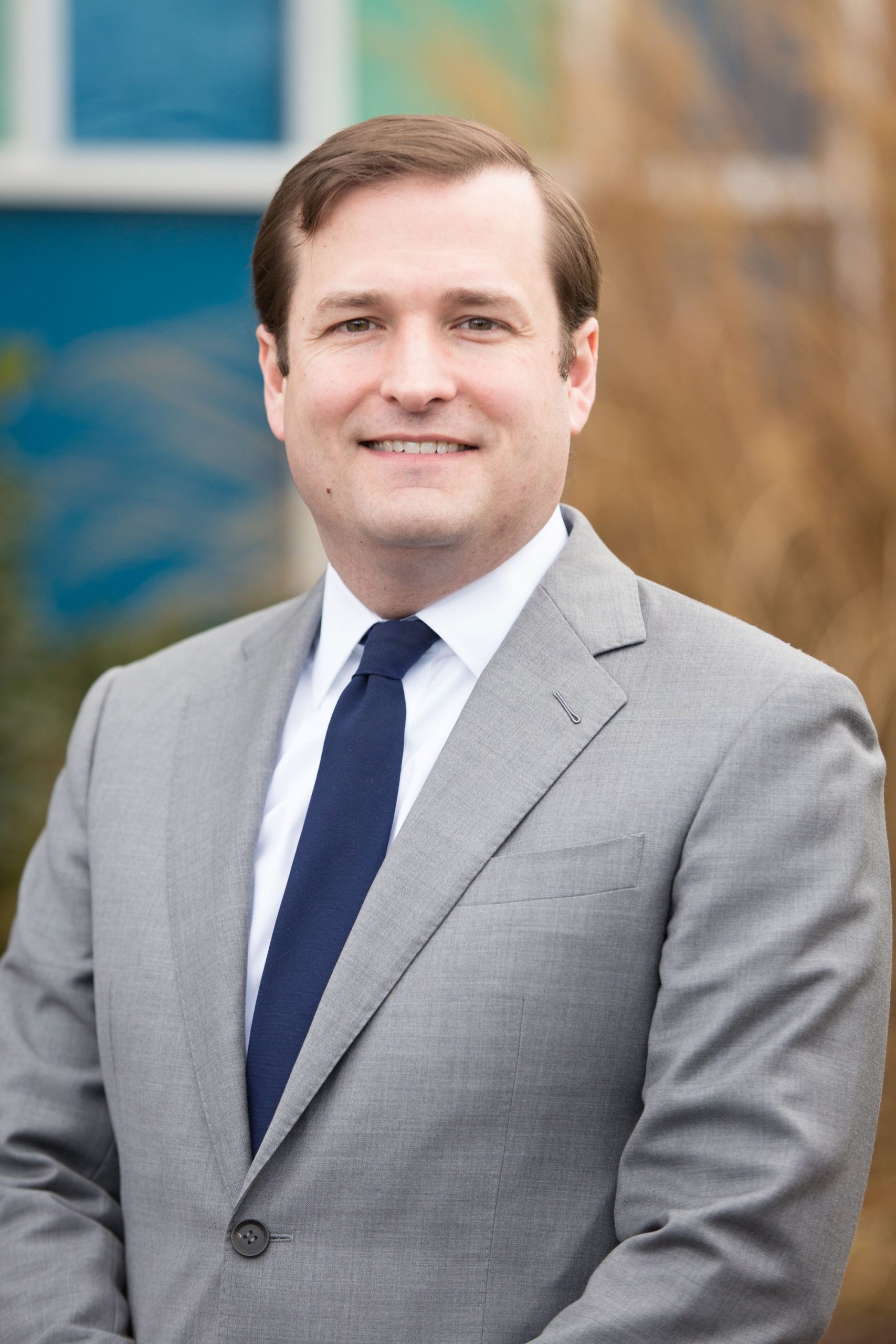 dark-haired man in grey suit